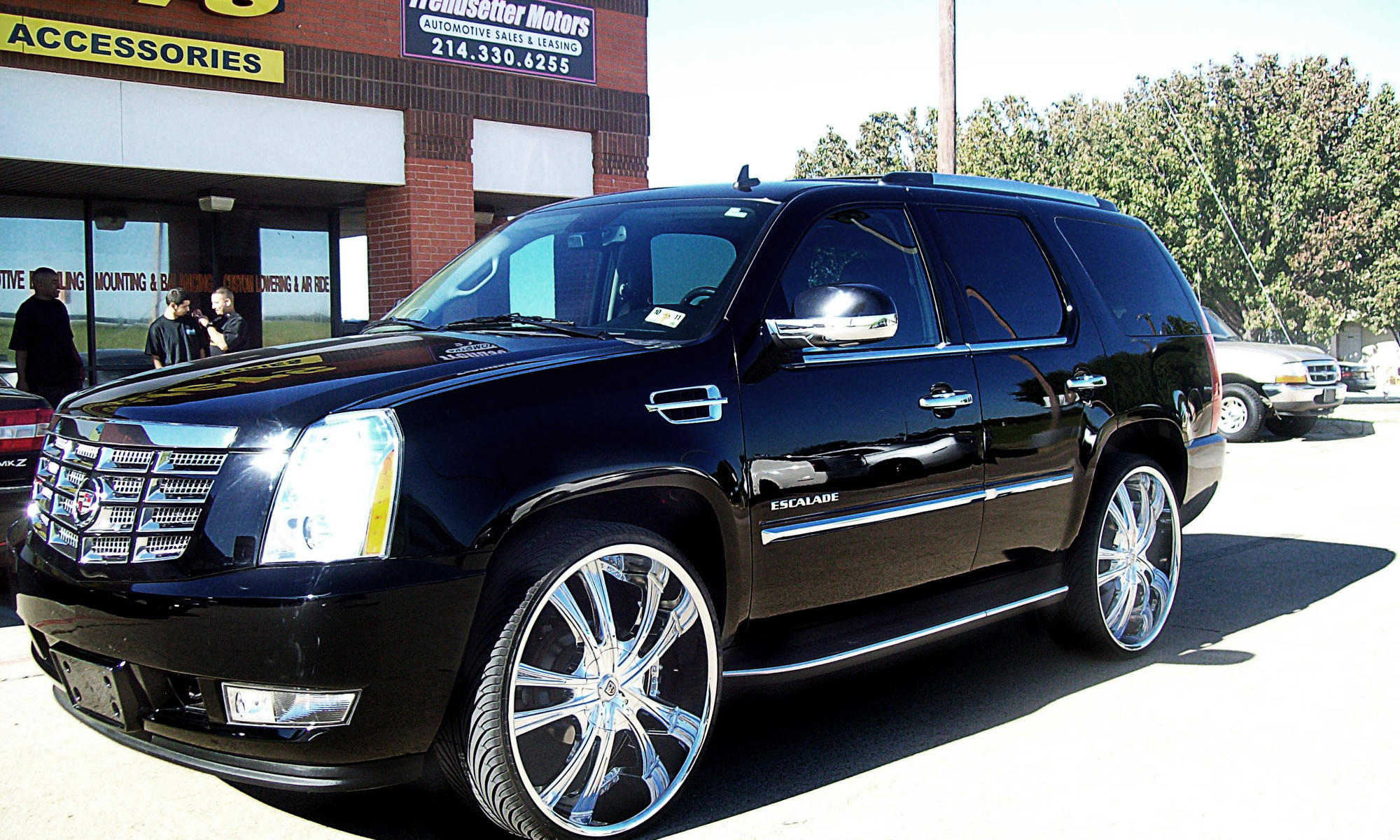 2011 Black Cadillac Escalade with chrome lss55 wheels and ss lip